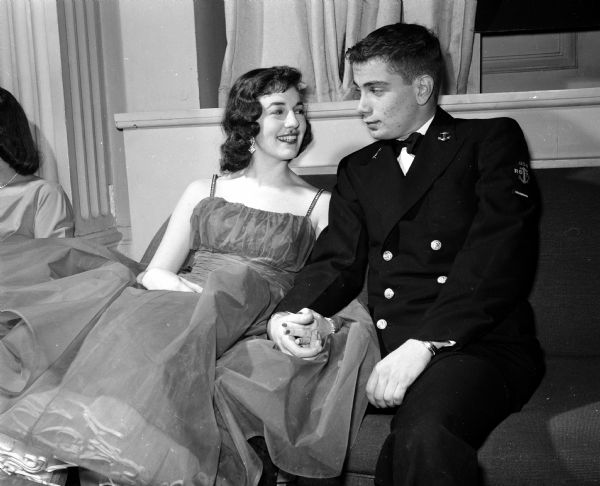 Greta Gross of Beaver Dam and her date, Dave Fauerland of Waukesha, sit and converse at the annual Navy Ball held for the Naval Reserve Officers Training Corps (NROTC) midshipmen at the Memorial Union's Great Hall.