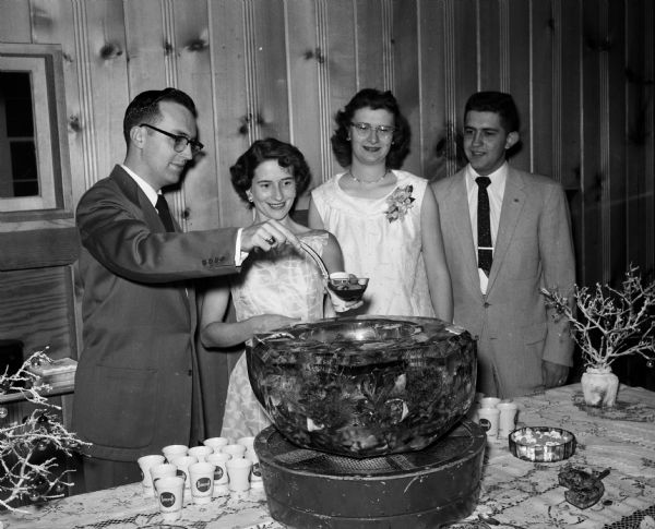 Donald (left) and Ruth Bongey and Mrs. and Mr. Joseph Warner, co-chairmen, gather around the punch bowl at the South Shore Methodist Church Young Adults Club Dance.