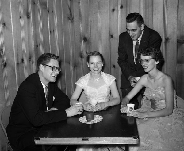 Reverend Richard Aukema and Murtice V. Aukema (left), and Beverly and Ronald Kneebone gather around a table while attending the South Shore Methodist Church Young Adults Club Dance.