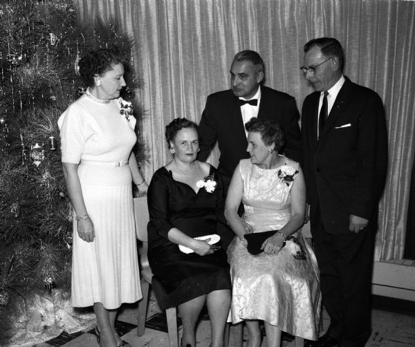 Attendees at a party for the Hult Capital Garage "family." Seated left to right: Myrtle Hult, Maude Petersen. Standing left to right: Elizabeth Lambrecht, George Lambrecht, and Chester Petersen.