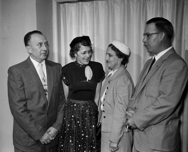 Four people standing beside each other during the Gardner Baking Company's 25-Year-Club celebration. They include Norman and Florence Schroeder; and Mrs. and Mr. Lyle Shepard.