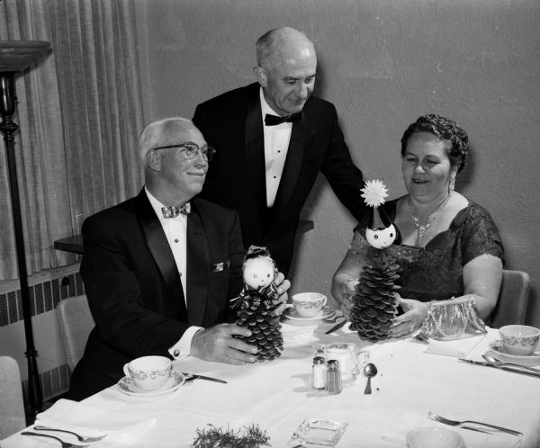Attendees at Nakoma Golf Club's New Year's Eve "Sno-Ball" admire the table decorations. They include, from left: K.A. Johnson, J.D. Howard, and Nita Howard.