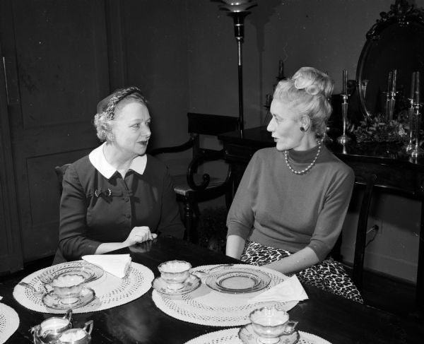 Plans are being completed for the organization of a Women's Auxiliary to the Dane County Bar Association. Wives of the lawyers will make up the membership. Louise Brown, membership chairman and Inez Toebaas, publicity chairman, sit together at a table.