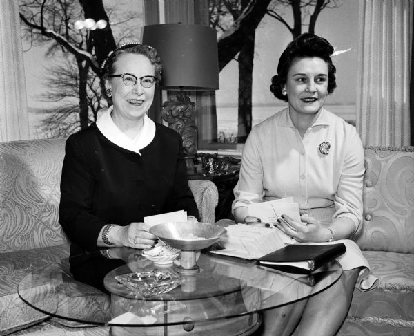 Plans are being completed for the organization of a Women's Auxiliary to the Dane County Bar Association. Wives of the lawyers will make up the membership. Left to right: Helen Sutherland, assistant chairman of the organizing committee, and Elenor Bjork, chairman of the organizing committee, check over letters to be sent out to prospective members. The first meeting of the Auxiliary will be held in April.