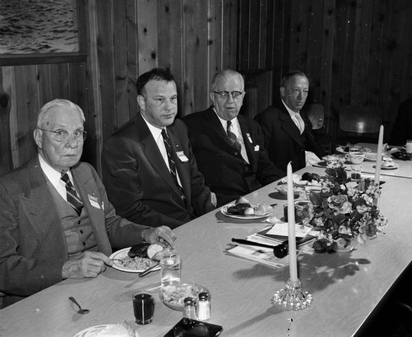 Four men present at a dinner observing International Printing Week. They include, from left to right: Emil. J. Frautschi, president of the board of directors of the Madison Vocational School; William S. Buchanan, president of the Madison Craftsmen club; R.W. Bardwell, director of the Vocational School and Fred Mason, director of the Board of Vocational Education.