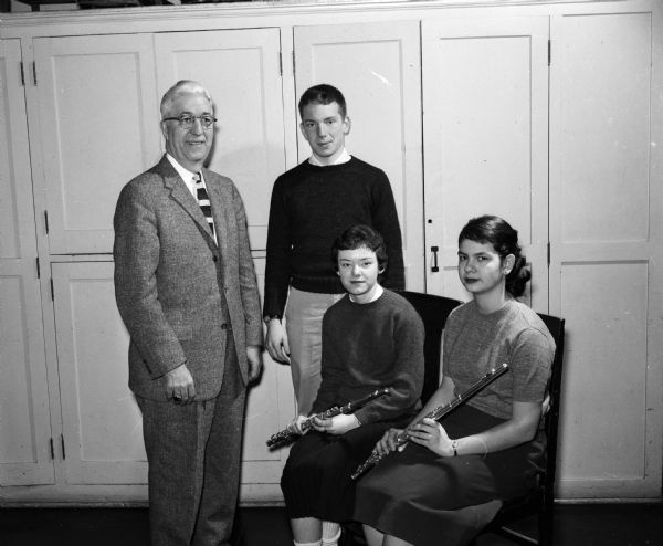 Prof. J. Russell Paxton (left) of the University of Wisconsin School of Music and director of the Wisconsin High Singers posing with participants in the World Day of Prayer program. With him, left to right, are Richard Schacht, Sue Matthews, and Letha Dreyfus.