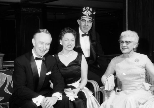 Governor Vernon Thomson and Helen Thomson socialize with Mr. and Mrs. Edward Dodge of Lake Mills while attending the Zor Shrine Potentate's Ball at the Hotel Loraine.
