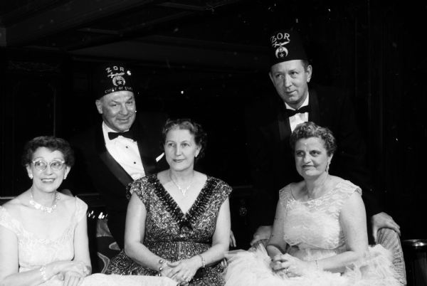 Among the Zor Shriners and wives attending the Potentate's Ball are: (seated left to right) Lucy Haspell, Ruth Mansfield, and Alethea Andrews. Standing are Arthur ("Dynie") Mansfield and Lyle Andrews.