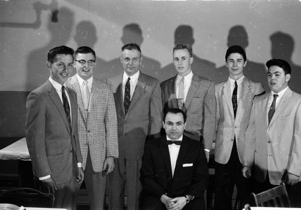 Pictured at the annual Waunakee High School Athletic Banquet are, seated: Dick Trotta, coach; standing left to right: Dave Williamson, 1957 football captain; Bill Adler, All-Tri-County League footballer; Principal Melvin Donner; George Solveson, also All-Tri-County footballer; Jim Laufenberg, most valuable player in football and also all-league; and Jim Koltes, most valuable player in basketball.