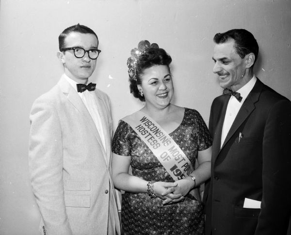 Vivian Soule (center), of Rt. 3 in Madison, was chosen as Wisconsin's most outstanding restaurant hostess at an open house held by the Madison Association. At left is Jim Noachek and right, Cosmos Hoffman.