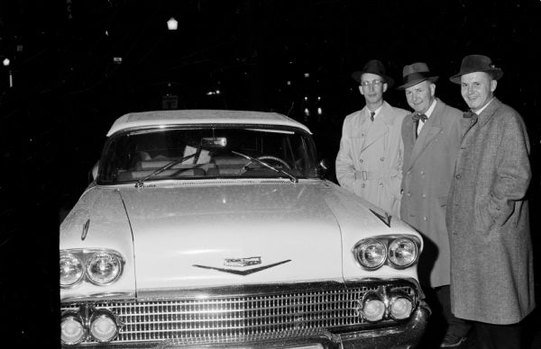 Presentation of a 1958 Chevrolet Impala convertible to John Walsh in appreciation for his 25 years service to Wisconsin boxing. Shown with the car, from left to right: John Hobbins, chairman of the testimonial dinner; John Walsh; and John Fish, co-chairman of the event.