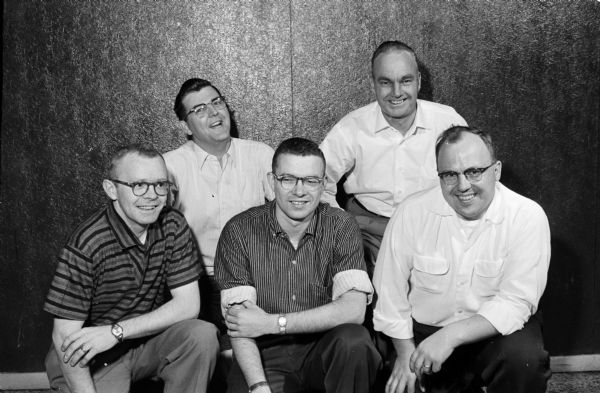 Group portrait of the five members of the championship team of the 1958 Madison Bowling Association tournament. They bowl for Farmers Mutual. Their names and scores are: front L-R, Phil Strand (527), Elmer Helser (623), and Lyle Sorensom (547).  In the back row are Fred Engelke (544) and Chris Hermanson (515).