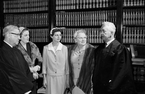 E. Harold Hallows, Milwaukee auttorney, is sworn in as a Justice of the Wisconsin Supreme Court. Shown with Justice Hallows are, from left to right, Chief Justice John E. Martin; Mrs. A.W. Heise, Chicago, the new justice's sister; Mary Elizabeth Hallows, his daughter; and Mrs. Hallows.
