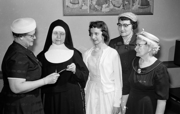 The hospital committee of the Madison Chapter, No. 291, of the Women of the Moose present a scholarship to a student nurse in a Madison hospital. Shown, left to right, are: Mrs. Kenneth Rehbein, 2309 E. Johnson Street, chariman of the hospital committee; Sister Mary Susanne, Director of St, Mary's Hospital School of Nursing; Miss Mary Ann Steinmetz, LaCrosse, the scholarship recipient; Mrs. H.C. Nelson, 2113 Linden Aveunue; and Mrs. Carl F. Raemisch, 611 Chapman Street.