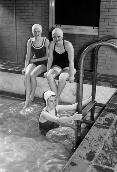 Almost 200 girls from 20 Wisconsin high schools took part in a strenuous day of recreation planned by the Women's Physical Education Club at Lathrop Hall at the University of Wisconsin. Coming up the ladder at Lathrop Hall pool is Patricia De Voy, Beloit, and sitting on the edge of the pool were Sandra Shanks, Merrimac, and Rachel Fairman, Beloit.