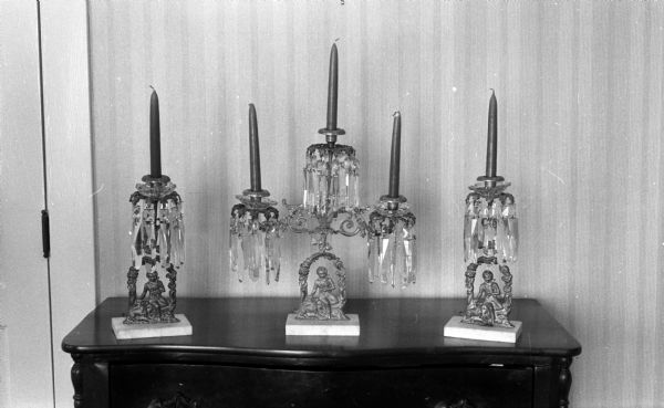 A table shot of a three piece bronze and crystal candelabra set that had been in the Elder family since 1853. "An identical set was made by the same craftsman for Abraham Lincoln at that time."