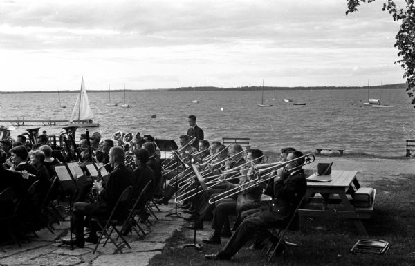 The University of Wisconsin band gives a summer concert at the Memorial Union.  Lake Mendota is in the background.