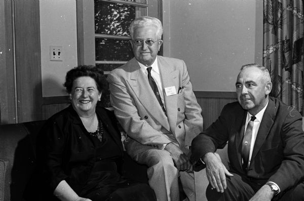 Seated at left is Bernice FitzGibbon, who was initiated as an honorary member of the Phi Chi Theta organization at their national convention held in Madison. Miss FitzGibbon, a native of Westport, lives in New York City. At center is F.H. Elwell, emeritus dean of the University of Wisconsin School of Commerce. At right is her brother, Gerald FitzGibbon, Wausau. Phi Chi Theta is a professional commerce fraternity for women.