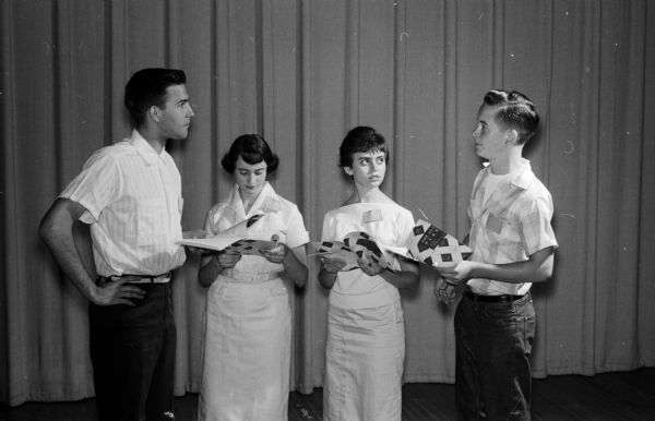 Four teenagers are standing and holding scripts while trying out for roles in the 1958 summer season. From left to right are Gordon Taylor, Susan Kearl, Donna Golfinos, and Doug Jewett.