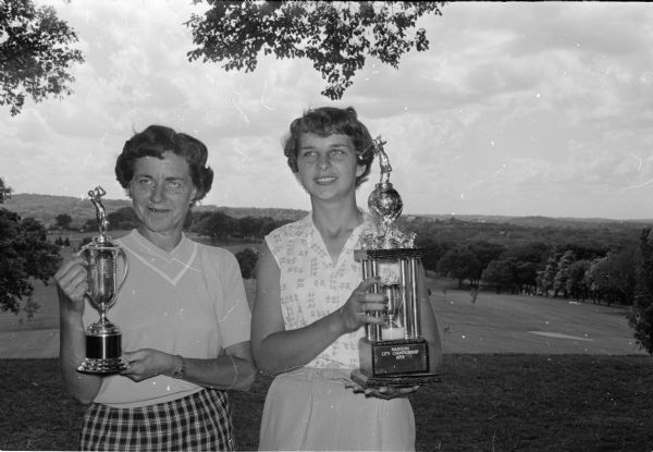 Mrs. Robert Severson, right, winner of the Madison's city golf championship and Margaret Hundt, runner-up, display their trophies at Blackhawk Country Club.