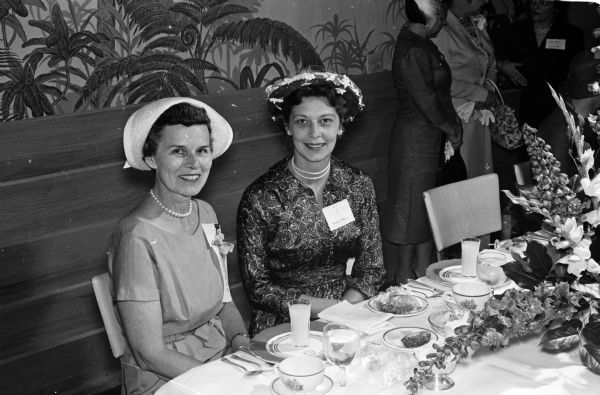 Many social events were planned for the wives who accompanied their husbands to a meeting at the Forest Products Research Society. Two active members of the women's committee are Alice Locke (left) and Geraldine Fitzpatrick.