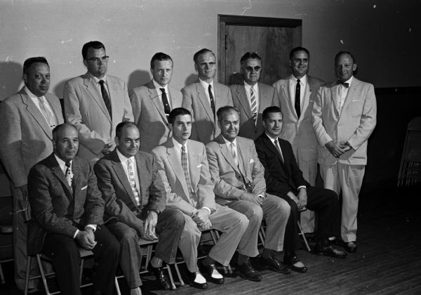 Group portrait of the new officers of Knights of Columbus Madison Council No. 531. Front row, left to right: John Koch, Prairie du Sac, district deputy; Joseph L. Tisserand, chancellor; Philip J. Croak, grand knight; George Stein, Verona, deputy grand knight; and R.R. Riesen, treasurer. Back row, left to right: Herman G. Kleinheinz, financial secretary; Edwin Kehl, outside guard; John E. Welch, warden; Arthur Flood, advocate; Leonard J/ Wagner, trustee; Wesley R. Shoberg, trustee; and Ted Wetternach, recording secretary. Not present were Wilfred Schlimgen, trustee; and Carl Sampson, Stoughton, inside guard.