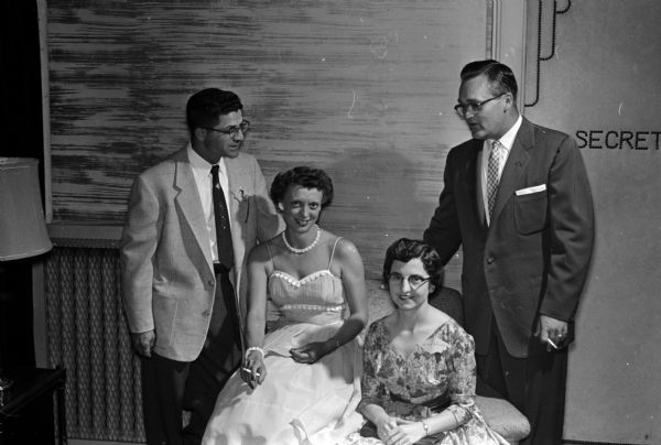 Members of the arrangements committee for the reunion chat between sets of the dance. Left to right, they are: Nick Petratta, Jane Teasdale, Josephine Petratta, and Joe Teasdale.