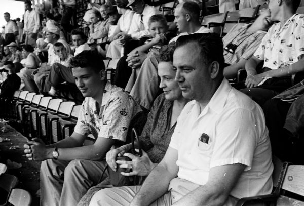 Madison newspaper carrier John Yount and his parents, Helen and Paul Yount, watch a Braves game in Milwaukee.
