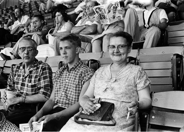 Chris Willadsen (left), son Steven Willadsen, and Gudrun Willadsen enjoy a Milwaukee Braves baseball game outing for newspaper carriers and their families.