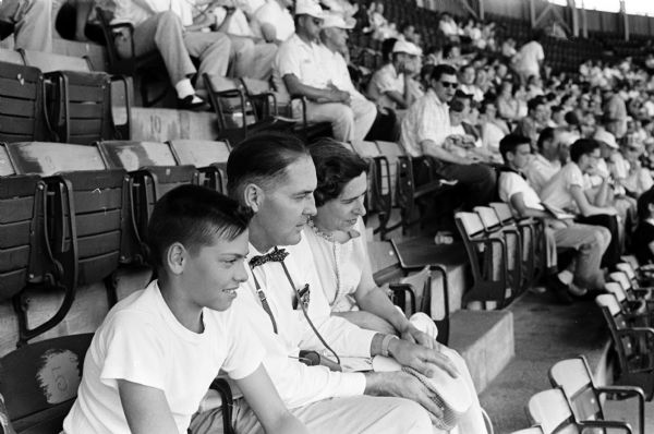 Thomas Wagner and his parents, R.D. and Ernestine Wagner, watch a Milwaukee Braves baseball game.