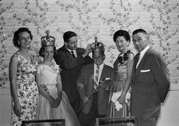 The crowning of the Bike Safety King and Queen begins Bicycle Safety Week at a Coronation Banquet. The King and Queen are shown with their parents. Left to right:  Anne Short, Queen Lyn Short, Roger Forester (MC), King Jerry Scott, Helen and Harold Scott.