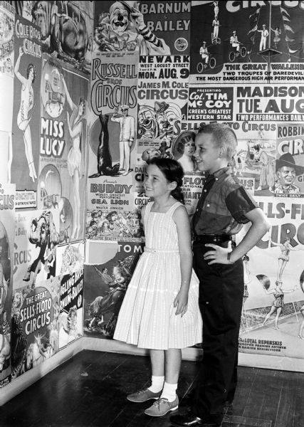 Christine and Bill Schuldt admiring posters and relics of circuses founded in Wisconsin at an exhibit in the State Historical Society Museum. The photograph was taken for part of an article suggesting Madison places and activities for summertime visiting.