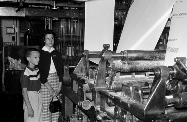 Pat, 8, and Vicki Rohan, 14, examine some of the equipment in the press room of Madison Newspapers, Inc. The photograph was taken for part of an article suggesting Madison places and activities for summertime visiting.