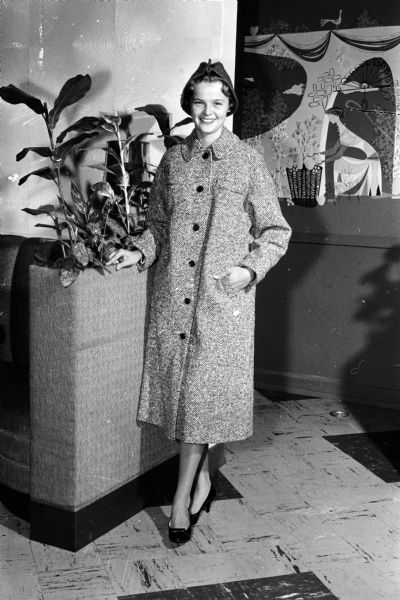 Ellen Herman models a tweed coat and a mohair casual hat.