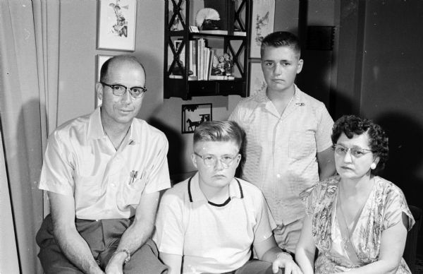Original caption states: "Everyone benefits. Jans Jackson, Spring Green, champion subscription salesman, of the <i>Wisconsin State Journal's</i> carrier boys, is shown with his family. They are from the left: Harold Jackson, his father, Jans, his brother Craig; and his mother." As his prize, he and his family won a weeks vacation at the Silver Arrow resort near Woodruff on Lake Gilmore with a cottage and free meals. Jans won by selling 49 subscriptions. "Craig also was a State Journal carrier, but he left the subscription selling up to his brother."