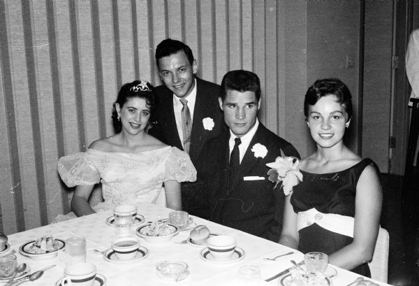 Two of the queen candidates are shown with their escorts. They are Marlys Hitzke (left) and Lenore Zamis (right). Their escorts are Bruce Creger and Harry Deupree. Miss Zamis was voted queen of the Prom by the dancers who attended.