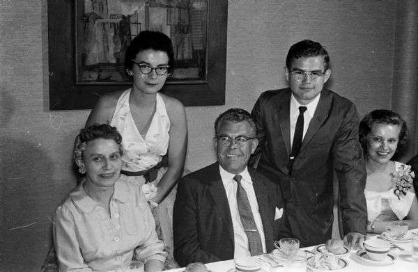 Mrs. and Mr. Arnold Langman, Racine, seated, were guests of their son, Wendell, standing right, at the pre-Prom dinner. Also shown at upper left is Deanne Chapman, a University of Wisconsin co-ed.