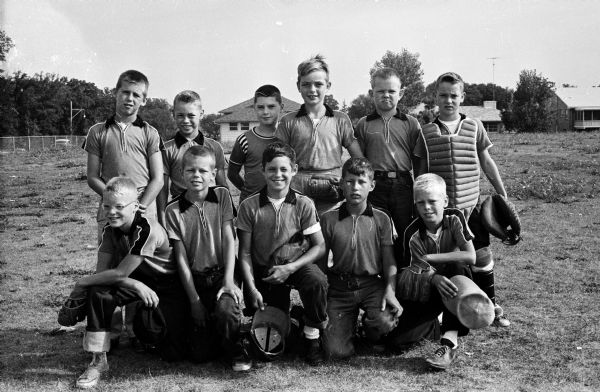 Portrait of the Kiwanis Midget baseball team after winning the Midvale No. 1 league title. Left to right, kneeling: Gordon Webb, David Young, Bill Draper, Jim Karpinsky, and Dave Mayland. Standing: Lynn Poole, Mark Bradley, Jerry Martin, Tom Gilbertson, Bob Pound, and Pete Bradley.