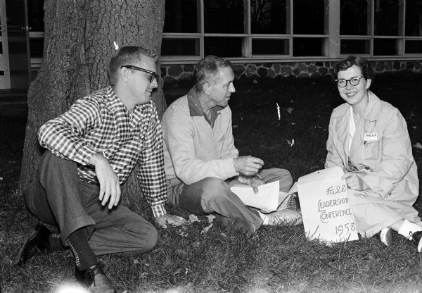 University of Wisconsin faculty members and students meet at the YMCA Camp Wakanda for the 9th annual Wisconsin Students' Association (WSA) student leadership conference. Shown (left to right): discussing the event are Don Olson, Kappa Eta Kappa, professional electrical engineering fraternity; C.H. Ruedisih, Associate Dean of the College of Letters and Science; and Marion Stahr, Women's Interhall committee.