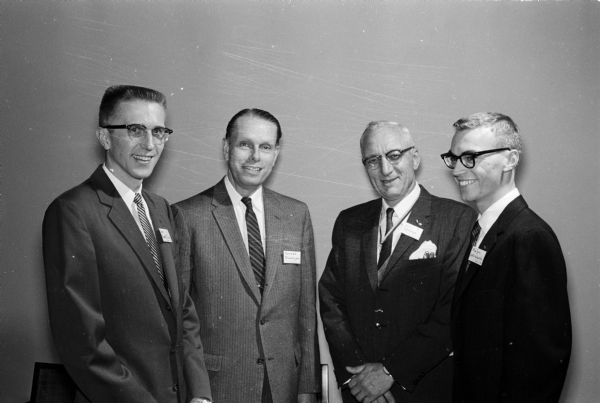 Initiation ceremony by the University of Wisconsin-Madison chapter of Alpha Kappa Psi professional business fraternity. Among those invited to the event were, from left to right: Jim Sueflow, Oshkosh; University of Wisconsin President Conrad A. Elvehjem; John R. Wrage, deputy counselor of the fraternity; and Ralph Catalanello, Delavan, secretary of the group.