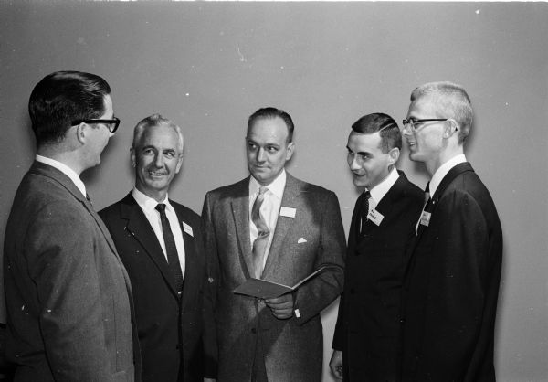 Initiation ceremony of the University of Wisconsin-Madison chapter of Alpha Kappa Psi professional business fraternity. Pictured are three actives of the fraternity with two members of the School of Commerce faculty. From left to right are: Jerry Barnes, Madison; School of Commerce Dean E.A. Gaumnitz; Edward Werner, assistant professor; Al Prieve, Sheboygan Falls; and Donald Richards, Lodi.