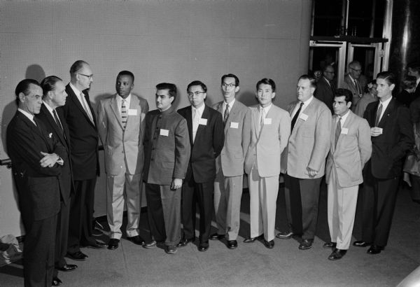 Representatives of overseas students' organizations were greeted by University President Conrad Elvehjem, Vice-Pres. Fred Harrington, and Prof. Jonathon Curvin, director of that nights play. Shown in the Wisconsin Union Theater lobby are, left to right, Curvin, Elvehjem, Harrington; Oliver Bright Jr., African Union; Dharam Kapoor, India Association; Hsien-Yin Niu, Chinese Association; Banji Hagihara, Japanese Association; Tong Boo Roh, Korean Student Association; Marcel Lortie, Canadian Student Association; Mohammed Alwan, Organization of Arab Students; and Julian Astiza, Latin American Association.