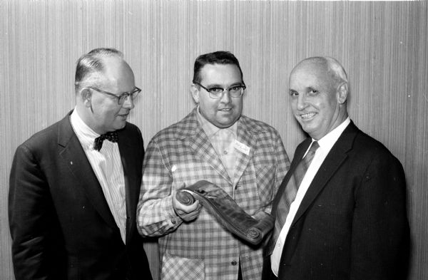 Willis Jones, right, former head coach of all sports, received a plaque for organizing and directing the club. Dr. William Rundell, center, and a 1938 graduate, presented the award. Don Viereg (left), 1934, was the first president of the club.