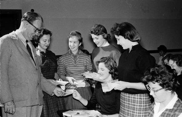 For their annual project, the West High School Girls' Club, a service club, stuffs the general "Roundy's Fun Fund" letters.