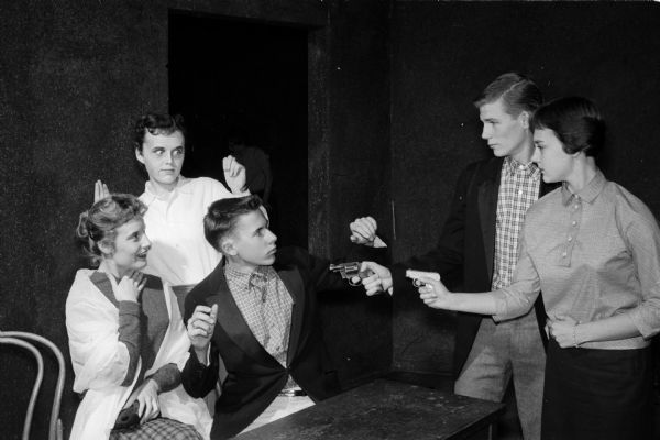 West High School presents the play "The Bishop Misbehaves". Pictured in rehearsal for the mystery comedy are Aleta Nelson, Mary Boyle and Paul Geisler, left, and Ray Huegel and Cookie Carnes, right.