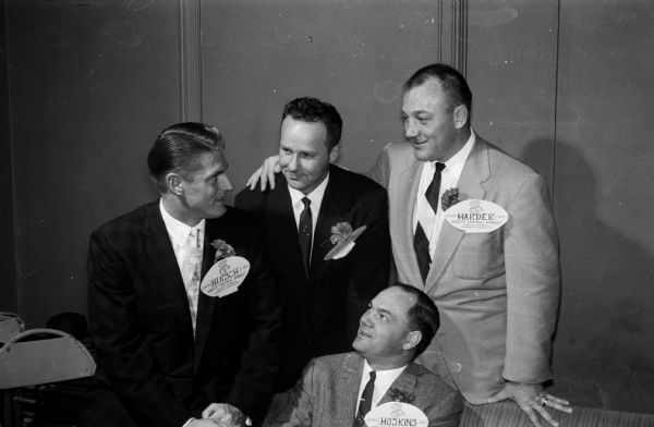 Among the featured guests at the football banquet was the starting backfield of the University of Wisconsin's famed 1942 football team. Seated is halfback Mark Hoskins. Standing, left to right, are: halfback Elroy Hirsch, quarterback Jack Wink and fullback Pat Harder.