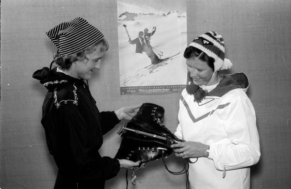 Evelyn Thomas and Pauline Wixson shown modeling ski fashions at the Madison YMCA Ski Club's meeting and fashion show.