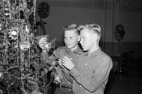 Children and parents of the Madison Twin Club held their Christmas party in the Community Center. Shown (left to right) are Michael and Maurice Glynn, 14-year old twins sons of Mr. and Mrs. L.M. Glynn.