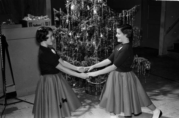 The Madison Twin Club held its Christmas party at the Madison Community Center. Shown (left to right) are Bonnie and Beth Jones, 11-year-old twin daughters of Mr. and Mrs. L.H. Jones.