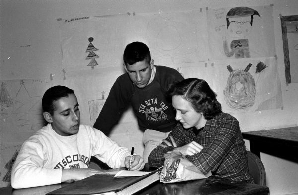 Members of Zeta Beta Tau fraternity at the University of Wisconsin took some of their free time to paint and repair at the Atwood Avenue Community Center. Planning the work schedule for the project are (left to right) Robert Rosenbaum, Milwaukee; Mike Litwak, Cincinnati; and Joanna Sherman, center director.